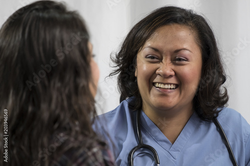 Medical professional sharing good news with female patient