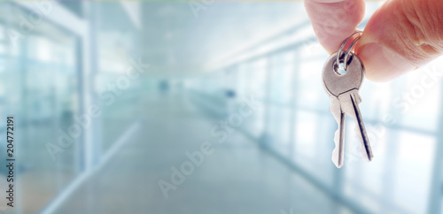 hand with keys and office, buy and rent