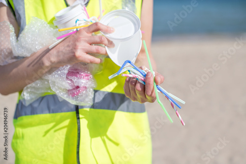 Close Up Of Person Collecting Plastic Waste From Polluted Beach © Daisy Daisy