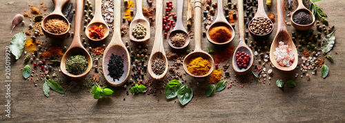 Herbs and spices on wooden board © Dionisvera