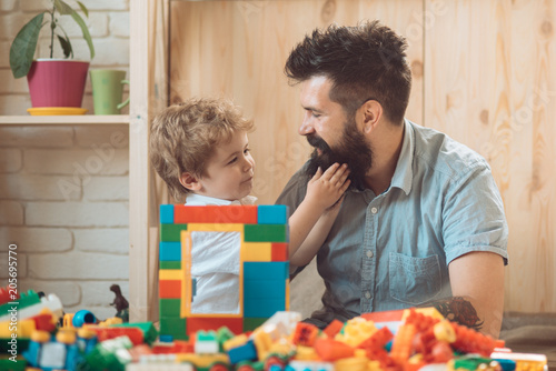 The boy touches his father's beard. An example and love. Tender feelings, family love. A good father. Father's Day. The son and father spend time together at home. A caring parent