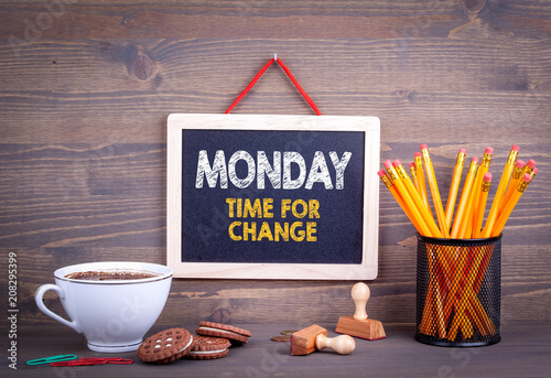 Monday time for change. Business Concept. Chalkboard on a wooden background.