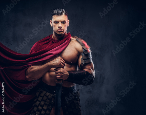 Brutal ancient Greece warrior with a muscular body in battle uniforms