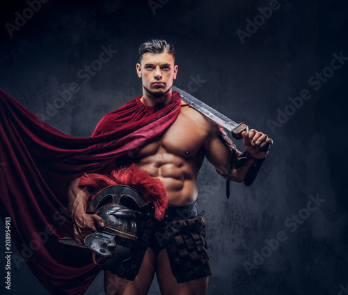 Brutal ancient Greece warrior with a muscular body in battle uniforms