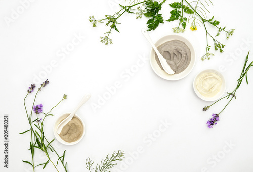 Natural cosmetics concept with various kinds of cosmetic clays and herbs © fortyforks