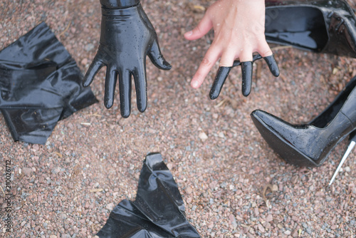 Two Hands In Torn Black Latex Gloves On Background Of Shoes Two Hands In Torn Black Latex Gloves On Background Of Shoes Rocky Beach Top