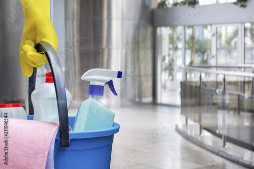 Cleaning lady with a bucket and cleaning products . © natali_mis