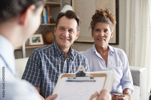 Senior Couple Meeting With Male Financial Advisor At Home