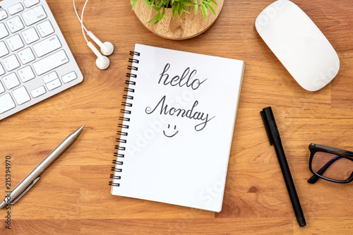 Notebook page with hello monday calligraphy text. Top view, flat lay.