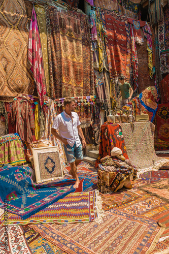 Young Man Tourist At An Old Traditional Turkish Carpet Shop In Cave House Cappadocia Turkey Young Man Tourist At An Old Traditional Turkish Carpet Shop In Cave House Cappadocia Turkey