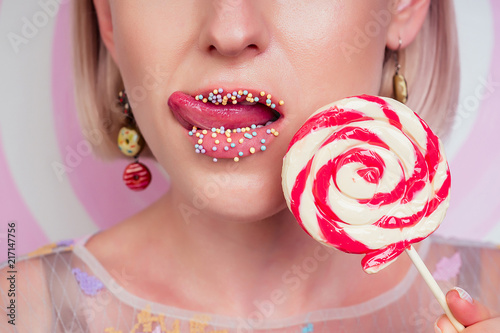 Portrait Of Beautiful Blonde Barbie Woman Perfect Makeup Tongue Sexy Licking Lip Lollipop Donuts Earrings In Portrait Of Beautiful Blonde Barbie Woman Perfect Makeup Tongue Sexy Licking Lip Lollipop Donuts Earrings In