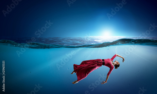 Woman dancer in clear blue water © Sergey Nivens