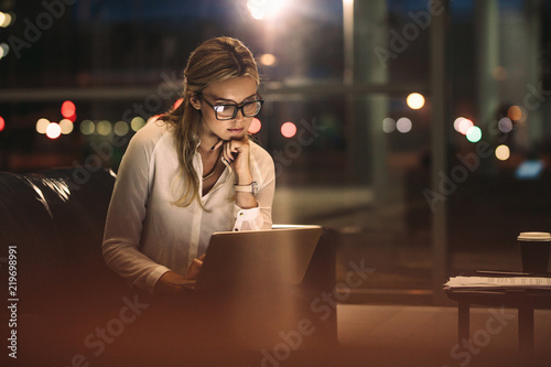 Business woman working late on laptop