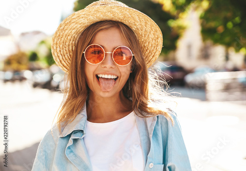 Portrait Of Beautiful Cute Blond Teenager Model In Summer Hipster Clothes Posing On The Street Background Portrait Of Beautiful Cute Blond Teenager Model In Summer Hipster Clothes Posing On The Street Background