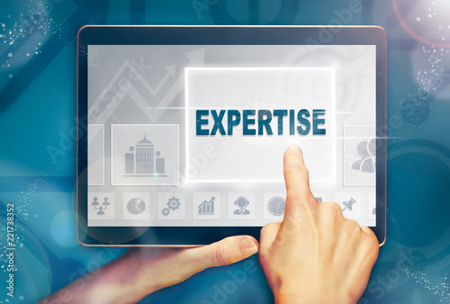 A hand selecting a Expertise business concept on a clear screen with a colorful blurred background.