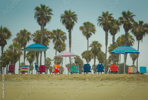 Beach Chairs That Sit Low To The Ground Are Lines Up On Beach Chairs That Sit Low To The Ground Are Lines Up On And Ready For Vacationers Upon Them Enjoy Their Beautiful Day By Sea