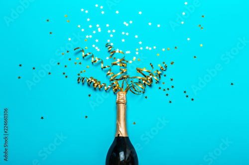 Champagne bottle with colorful party streamers © fotofabrika