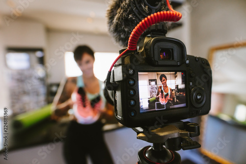 Social media influencer recording video for blog