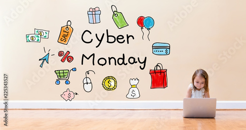 Cyber Monday text with little girl using a laptop computer on floor