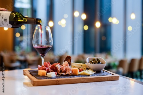 waiter serving red wine in a restaurant