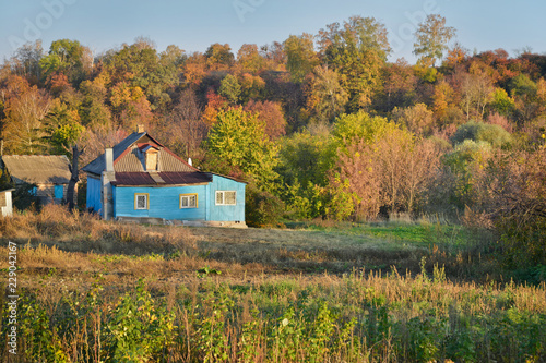 Small rustic home with adjoining vegetable garden in autumn time. Rural life. Ukraine. © olenaari