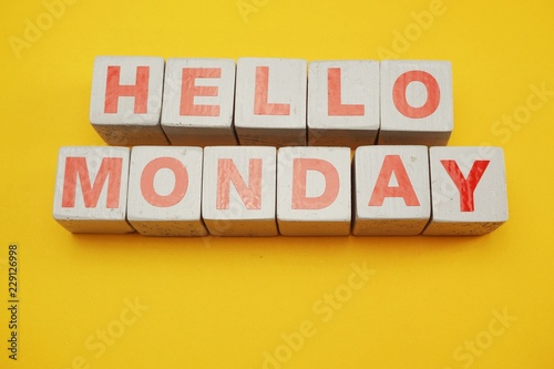 Hello Monday wooden letter alphabet on yellow background