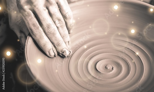 Hand of potter doing clay pot on
