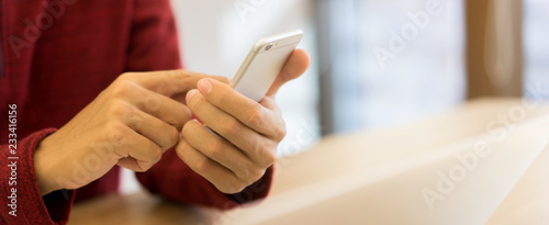 close up man hand holding smartphone and using application on device concept