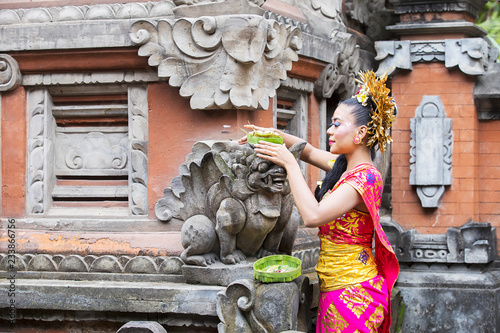 Balinese woman putting offerings in temple © Creativa Images