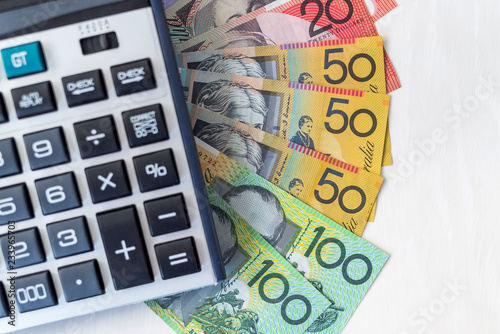 Calculator With Colorful Australian Dollars On Wooden Table Calculator With Colorful Australian Dollars On Wooden Table