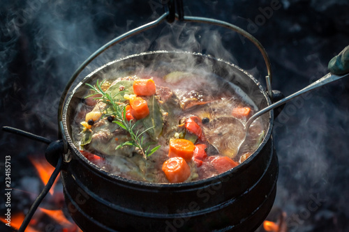 Hot and yummy hunter's stew on bonfire