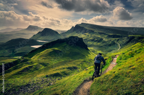 Mountain biker riding through rough mountain landscape of Quiraing, Scotland © Martin M303