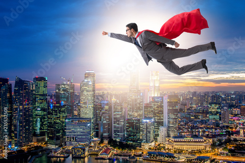 Superhero businessman flying over the city