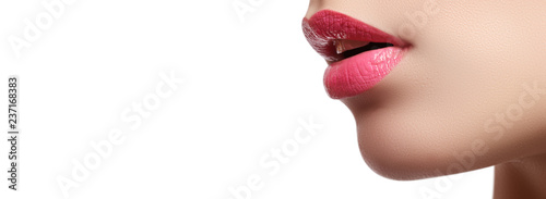 Close-up of woman's lips with bright fashion pink glossy makeup © looking2thesky