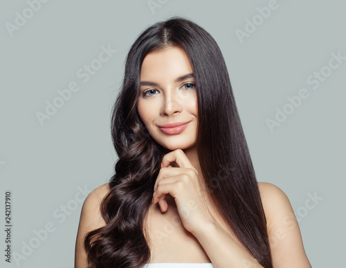 Young beautiful woman with straight and curly hairstyle. Hair styling and hair care concept. Young brunette woman © millaf