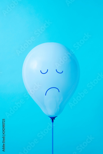 blue balloon with a sad face