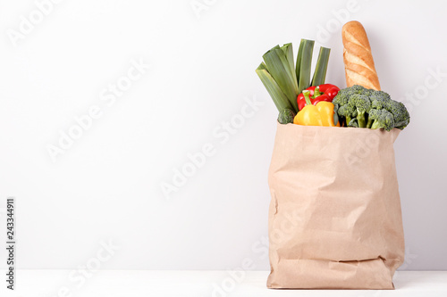 Grocery shopping bag with food on grey background