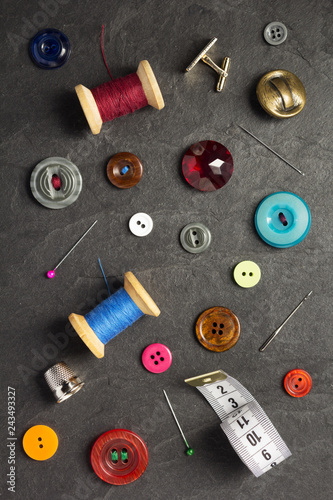 sewing tools and accessories on slate stone © Sergii Moscaliuk