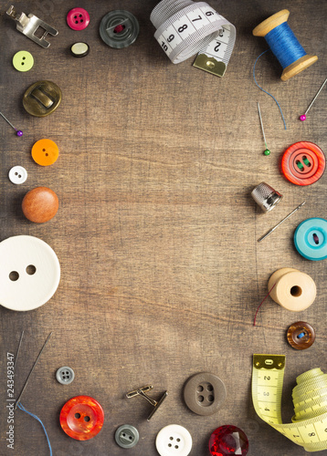 sewing tools and accessories on wooden table © Sergii Moscaliuk