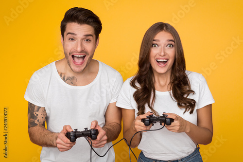 Man and woman playing together video games © Prostock-studio