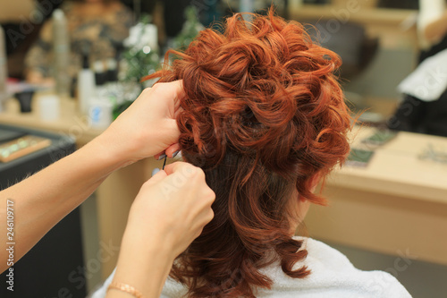 Hairdresser makes beautifull hairstyle at the salon © ukrolenochka