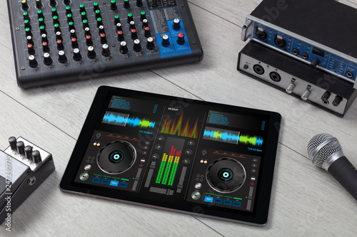 Mixing music on tablet with electronic music instruments concept © ra2 studio