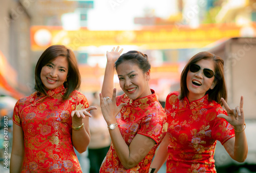 group of asian woman wearing chinese tradition clothes toothy smiling face happiness emotion and hand sign i love you © stockphoto mania