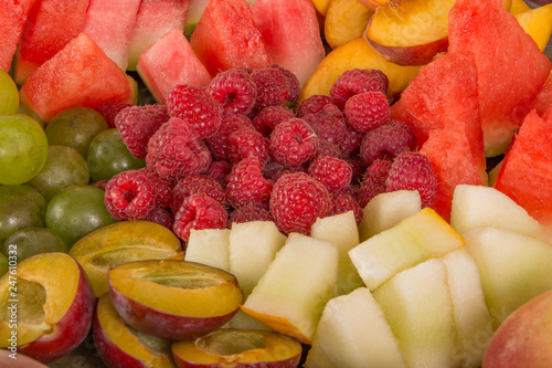 Fruit mix. Peach, grapes, apple, watermelon, melon, raspberry, plum. Juicy and ripe pieces of fruit close-up. © Fordvika