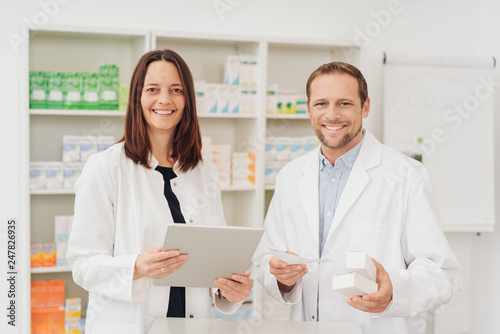 Two happy friendly pharmacists in a pharmacy © contrastwerkstatt