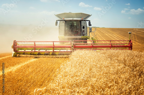 combine harvester working on field © ArtistGND