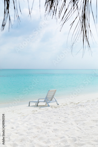 Sun chair on sandy beach at tropical vacation, © photopixel