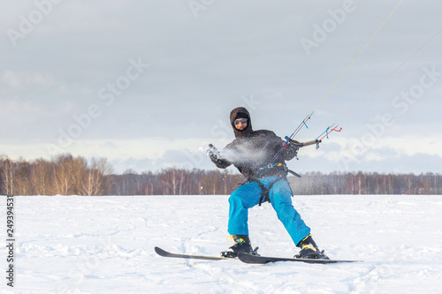 The skier goes on the snow field with kite © Alexey Laputin