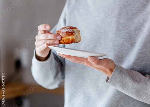 Man eating donut on breakfast at kitchen © Masson