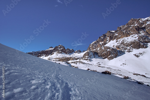 High altitude mountain path in the snow in High Atlas mountains Morocco with view of the valley © Lukas